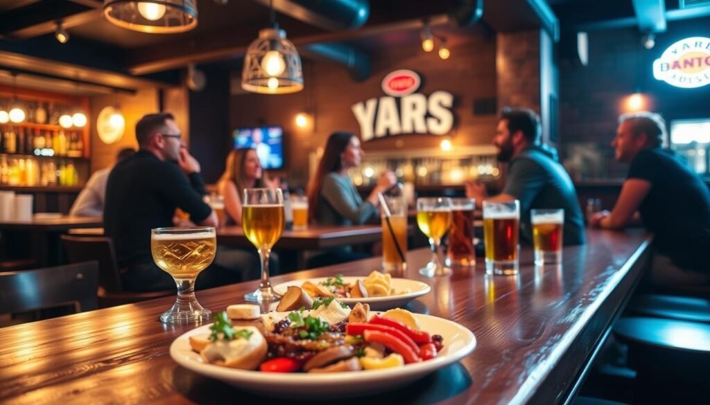 A cozy and inviting bar scene, with a wooden table in the foreground featuring a selection of appetizers and drinks. In the middle ground, a group of friends enjoying conversation and laughter, while the background showcases the warm, dimly lit ambiance of the Yard House restaurant. The lighting is soft and atmospheric, creating a convivial and relaxed mood. The camera angle is slightly elevated, giving a sense of immersion and highlighting the overall scene.